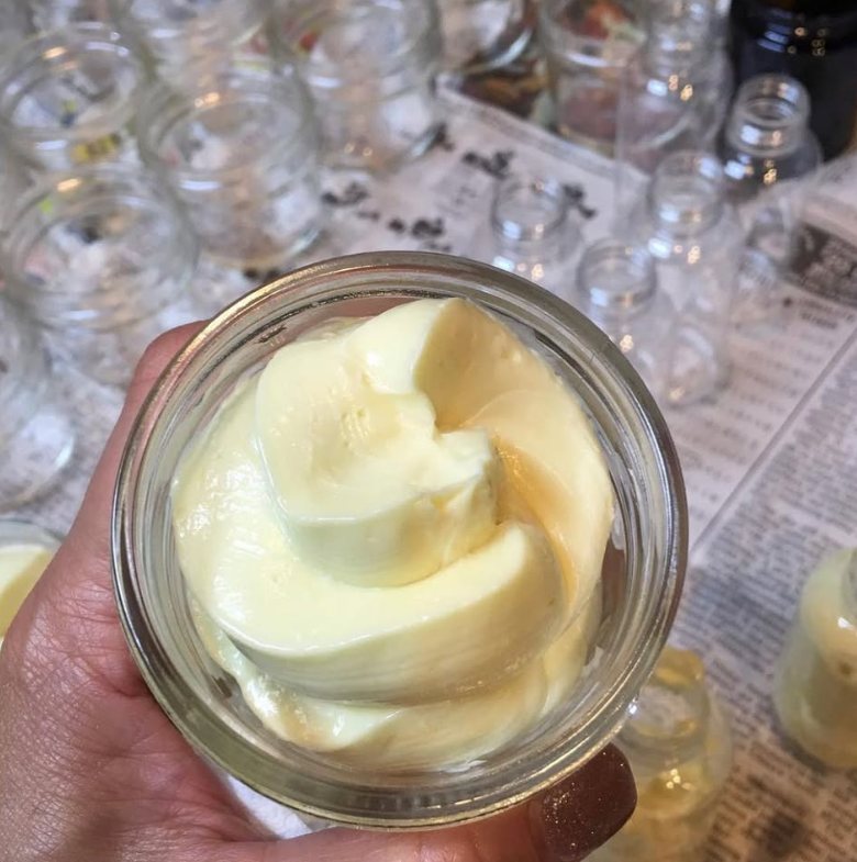 An open jar of whipped hand and foot cream