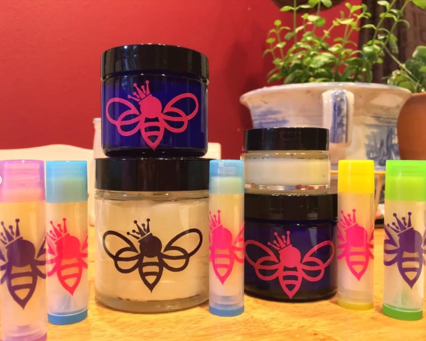 Lip balm tubes and face cream jars with the crowned bee