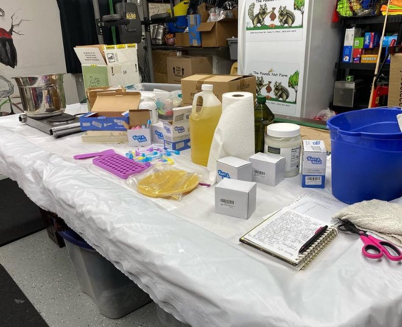 Toni's work table with a hot plate, notebook and supplies